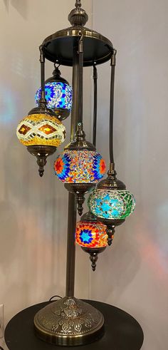 a lamp that is sitting on top of a table with many different colored glass balls