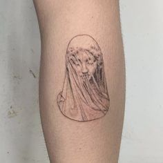 a woman with a veil on her head is depicted in this tattoo design by the artist