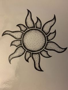 a drawing of a sun with dots on it