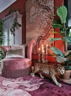 a living room filled with furniture and a leopard statue next to a painting on the wall