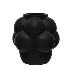 a black vase with four balls on it's face and the top half of its body