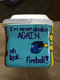 a blue and yellow lunch box sitting on top of a white tablecloth covered floor