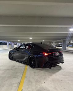 a black sports car parked in a parking garage