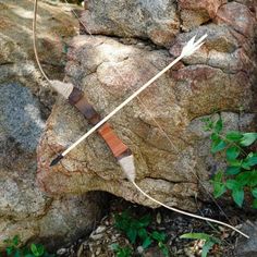 a bow and arrow stuck in some rocks