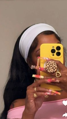 a woman taking a selfie with her cell phone in front of her face and wearing a headband