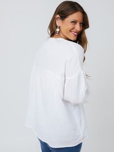 Cut from a soft, gauzy white cotton, this boho top makes every day feel like a beach day. There's something about an effortless statement earring that really brings out the best in this lightweight top with an easy fit. Fit Note: Designed to be roomy and flowy. Those that prefer a more fitted garment or that are in between sizes will want to size down 100% cotton Length of size M is 27" from top of bodice Made fair trade in India by one of our longstanding production partners Cotton V-neck Peasant Top For Vacation, White Relaxed Fit Breezy Tops, Breezy White Tops For The Beach, Relaxed Fit Summer Tops For Brunch, Breezy White Tops For Beach, Breezy White Beach Tops, White Breezy Vacation Top, Breezy Cotton Top For Day Out, Bohemian Cotton Tops For A Day Out