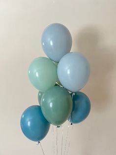 a bunch of blue and green balloons in a vase