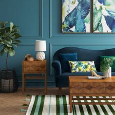 a living room with blue walls and green accents