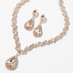 This jewelry set comes with a beautiful shimmery V-neck necklace and matching 1" drop earrings that both have a rose gold-tone finish and clear glass rhinesones. Wear this set to your next special occasion for a glammed up look. Pack Size: 2 Finish: Rose gold-tone Necklace Length: 16" + 3" extender Necklace Closure: Lobster clasp Earring Drop: 1" Earring Closure: Post back Material: Metal - Claire's Rose Gold Crystal Teardrop V-Neck Jewelry Set - 2 Pack Rose Gold Jewelry Set, Prom Necklaces, Rose Gold Crystal, Fashionable Jewelry, Neck Jewellery, Gold Crystal, Jewellery Set, Gold Tone Necklace, Rose Gold Jewelry