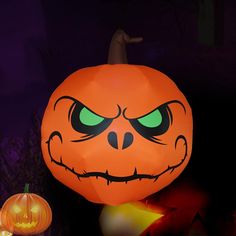 an inflatable pumpkin with glowing green eyes