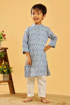 This is a traditional kurta for the boys. It is made from 100% pure cotton, has a Chinese collar and long sleeves in a pretty colour with traditional prints throughout. Composition: 100% cotton cambric Features Grey Blue colour Geometric print Coconut buttons Mandarin collar Relaxed fit Regular full sleeves Wash care : Hand wash separately in cold water. Use mild detergent. Dry in shade. Light Blue Cotton Kurta For Diwali, Traditional Blue Cotton Kurta, Light Blue Cotton Sets For Diwali, Light Blue Cotton Diwali Sets, Diwali Light Blue Cotton Sets, Casual Cotton Traditional Wear For Diwali, Light Blue Cotton Kurta With Long Sleeves, Light Blue Cotton Sets For Eid, Light Blue Long Sleeve Cotton Kurta