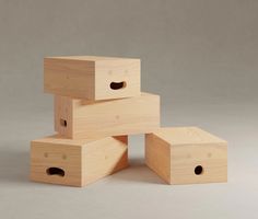 four wooden boxes stacked on top of each other with holes in the middle and one missing