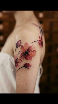 a woman's arm with flowers painted on it