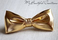 This trendy and stylish bow tie is great for so many occasions!Bow tie made of 100% cotton with a matching, adjustable neck strap. Style:• The Pre-Tied Bow Tie• The Clip-On Bow TieAll our bow ties can be made in the following sizes, just specify which size you need in a note at checkout: Sizes:Baby: 3.5" x 2"Kids: 4" x 2"Youth:  4.25" x 2.25Adult: 5" x 2.5"All our bow ties are made by hand; therefore, measurements are a guideline only and cannot be guaranteed. Neck strap sizes:Baby – adjustable Wedding Bow Tie Groomsmen, Bow Tie Ring, Bow Tie Groomsmen, Tie Ring, Gold Bow Tie, Wedding Bow Tie, Ring Boy, Groomsmen Bowtie, Pre Tied Bow Tie