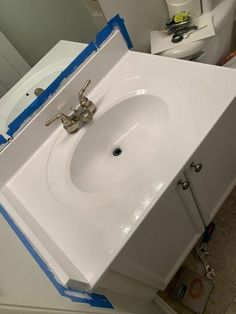 a white sink sitting on top of a bathroom counter