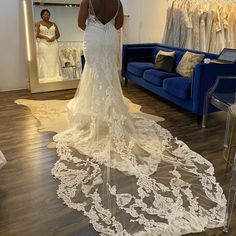 a woman is looking at her wedding dress in the mirror