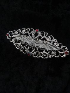 Vampire hairslide/comb Beautiful simple Filigree hair accessory with central bat design and added rhinestones.  Perfect addition to our Vampyre series. Rhinestone colour can be changed on request. The image shows the red stones. Choose between slide or comb design.  Handmade to order, Ready in 3-5 days. May take longer during busy times. Marceline Cosplay, Vampire Hair, Alt Accessories, Comb Design, Goth Fits, Goth Outfit Ideas, Antler Earrings, Bat Design, Gothic Hairstyles