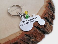 a keychain that says, my belongs to a critter on it