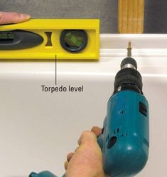 a person using a drill to fix a sink faucet with the topper level