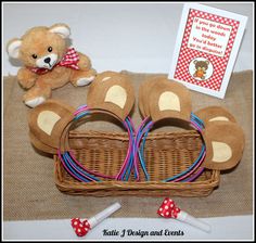 a teddy bear sitting on top of a table next to some baskets with shoes in them