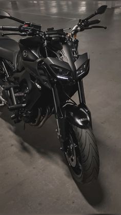 a black motorcycle parked in a parking garage