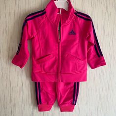 She Can't Go Wrong With This Classic Adidas Track Suit. Deciding What To Wear Just Got Easier When She's Got This Girl's Outfit To Mix And Match. Both Pieces Feature The Signature Sheen Of Tricot For Og Style. Jacket- Slanted Pockets Keep Hands Warm Set Includes- 1 Jacket And 1 Jogger Pants Pants- Elastic Waist And Cuffs For A Snug Feel Jacket- Full-Zip With Mock Neck. Nwt Sporty Pink Long Sleeve Sets, Pink Adidas Sports Outerwear, Pink Winter Sports Sets, Pink Hooded Sets For Fall, Adidas Fitted Winter Sets, Winter Adidas Fitted Sets, Pink Playwear Sets For Fall, Adidas Cotton Sets For Winter, Adidas Long Sleeve Playwear Sets