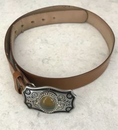 VINTAGE Leather BELT & BUCKLE SILVER tooled BUCKLE WITH Small POLISHED Agate or Jasper STONE Good Pre-owned condition.  Stone is beautiful.  Leather is tan/caramel color  Leather belt measures 38", buckle is an additional 2.5". (stone is 1" in length, 3/4" in width. Smoke free home. Vintage Brown Belt As A Gift, Adjustable Western Belt Buckles For Everyday Use, Vintage Brown Belt As Gift, Vintage Adjustable Belt For Western-themed Events, Vintage Brown Belt For Gift, Vintage Brown Jewelry For Western-themed Events, Vintage Leather Jewelry With Concho, Vintage Brown Leather Jewelry, Vintage Leather Adjustable Belt Buckles