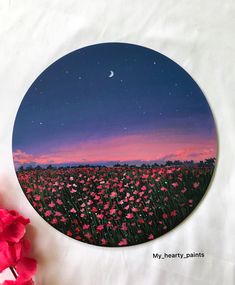 a painting of pink flowers and the moon