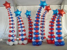 red, white and blue balloons are arranged in the shape of stars on top of each other