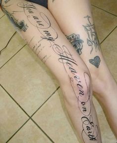 the legs of a woman with tattoos on them and words written in cursive writing