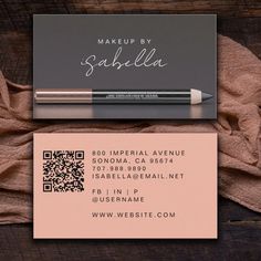 a business card with a pen on it next to a piece of paper that says makeup by sabella