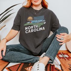 Show your love for the Tar Heel State with our North Carolina T-shirt! 🏞️ Whether you're a North Carolina native or a traveler exploring the state's stunning mountains, beaches, and rich history, this vintage-inspired t-shirt is the perfect way to represent North Carolina. Featuring a retro design and soft cotton fabric, this comfortable tee is ideal for casual outings, vacations, or as a unique souvenir from your North Carolina adventures. Perfect for North Carolina locals and travelers: Wheth North Carolina Gifts, Diverse Beauty, Tar Heel, Great Smoky Mountains, Vintage Graphic, Retro Shirts, Vintage Tee, Smoky Mountains, Outer Banks