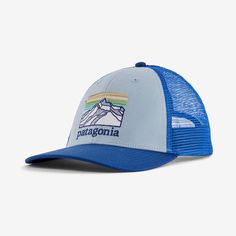 the patagonia trucker hat in blue and white with mountains on it, front view