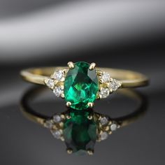 "Handmade by an inspired jewelry artist team with decades of experience in the craft of jewelry making. Each gemstone, each diamond is carefully picked. Using only the finest raw materials and the highest industry standard in manufacturing, design and finish. A beautiful vintage inspired piece handmade just for you. Set with a beautiful 7x5 mm Green Chatham Emerald Grade AAA, Oval cut, 1.05ct and 6 sparkling Diamonds, 1.75 mm, VS-E 0.13 ctw. The ring has a dainty band of 1.3 mm so perfect for da Emerald Ring Vintage, Dainty Band, Aquamarine Jewelry, Everyday Rings, Alternative Engagement Rings, Antique Inspiration, Emerald Engagement Ring, Cluster Ring, Emerald Ring