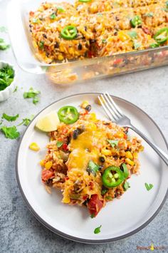 mexican rice casserole on a plate with a fork next to the casserole