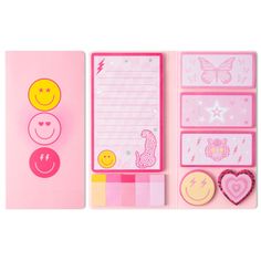 a variety of stationery items are arranged on a pink background with butterflies, hearts, and smiley faces