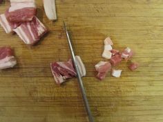 chopped meat is being cut up on a cutting board