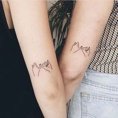 two people with matching tattoos on their arms