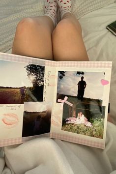 a person laying in bed with their legs crossed and holding an open photo book that has pictures of people on it