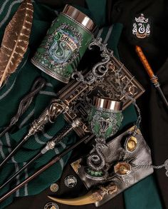 harry potter mugs, wands and other items on a green tarp cloth