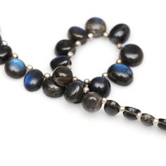 a black and blue beaded necklace on a white background