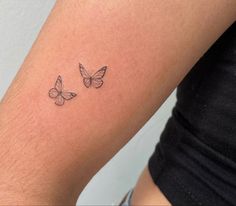 two butterflies tattoo on the arm