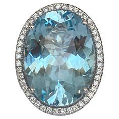 Exclusive exceptionally large handmade ring in 18 kt white gold ring with an oval faceted cut blue topaz of 34.00 ct!!! surrounded by 76 brilliant-cut diamonds, approx. 1.00 ct, H/VS/SI quality. Rank: 750 (marked) Natural Blue Topaz - 34.00 ct (treatment unknown) 48 stuks - approx. 0.50 ct, 26 stuks - approx. 0.50 ct Ring head size: 22mm x 29mm Weight: 17.9 grams Ring Size: 17.50mm/ 71/4 USA Comes in a ring box. Working for couple of years for one of the famous diamond factories in The Netherlan Diamond Cocktail Rings, Sky Blue Topaz, White Gold Ring, Ring Box, Brilliant Cut Diamond, White Gold Rings, Cocktail Rings, Handmade Ring, Blue Topaz