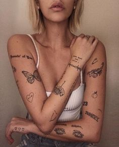 a woman with many tattoos on her arms