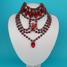 Our crystal jewellery collection is perfect for anyone who loves to accessorize with pieces that are both unique and stylish. Each Choker is made by hand to ensure the highest level of quality and artistry. The backing is coated in our trademark gunmetal coating. Colour - Red If there a colour you want, give us a message. We can do custom colourways if we have the crystals in stock. Handmade Gothic Body Jewelry For Party, Red Gothic Jewelry For Party, Elegant Body Jewelry Choker For Gift, Elegant Choker Body Jewelry Gift, Red Victorian Jewelry For Evening, Handmade Gothic Jewelry For Party, Gothic Wedding Necklaces With Jewels, Victorian Party Jewelry With Jewels, Party Jeweled Choker Jewelry