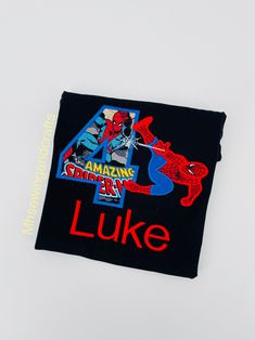 a black t - shirt with the number four on it and spiderman's face