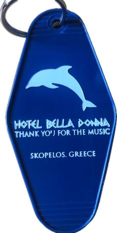 a blue keychain with a dolphin on it's side and the words hotel hella domia thank you for the music