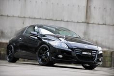 a black sports car parked in front of a building