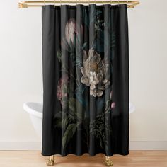 a black shower curtain with flowers and leaves on the outside, in front of a white bath tub