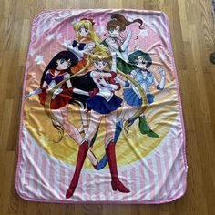 there are many anime characters on this pink and white bed sheet that is laying on the floor